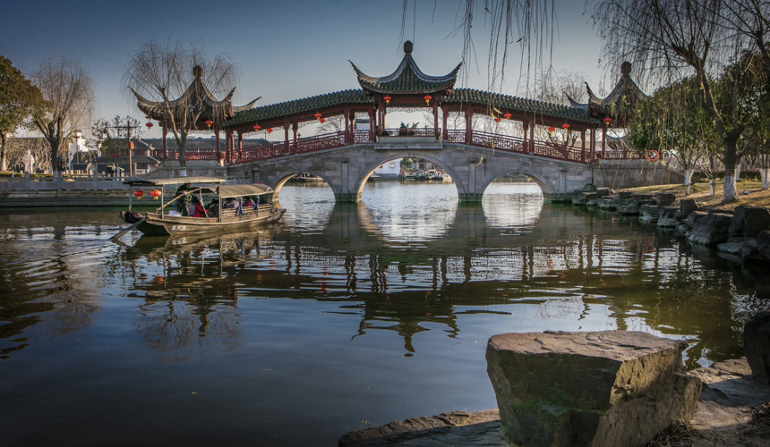 Covered walkways, lantern-lit canals, and old residences in scenic Xitang water town.