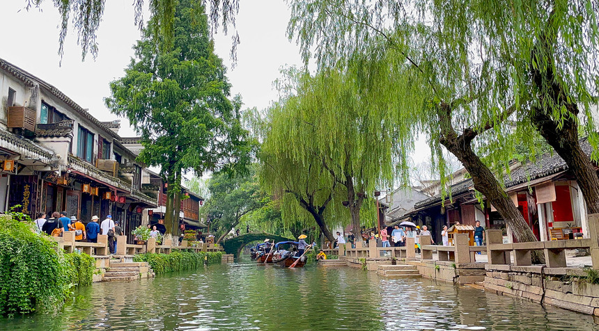Iconic twin bridges over narrow canals surrounded by historic houses in Zhouzhuang water town.