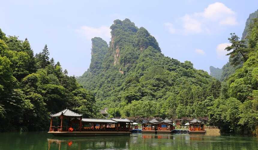 Serene Baofeng Lake surrounded by lush mountains and mist in Zhangjiajie