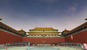 The Meridian Gate entrance of the Forbidden City with towering red walls, arched gateways, and traditional yellow roof tiles.
