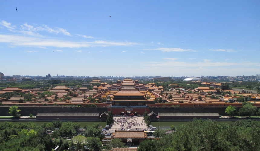 Panoramic view of the Forbidden City in Beijing with golden palace roofs, red walls, and expansive imperial courtyards.