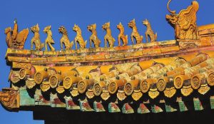 Close-up of the Hall of Supreme Harmony roof with golden glazed tiles, intricate ridge decorations, and mythical roof figures.