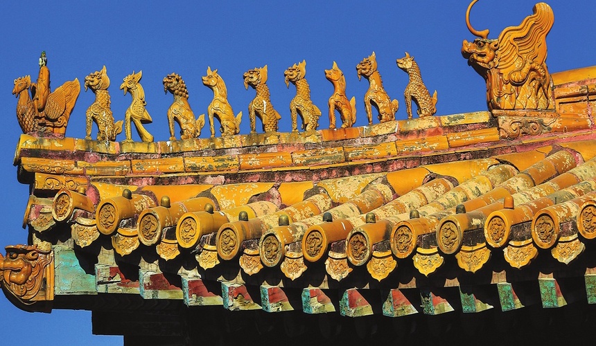 Close-up of the Hall of Supreme Harmony roof with golden glazed tiles, intricate ridge decorations, and mythical roof figures.