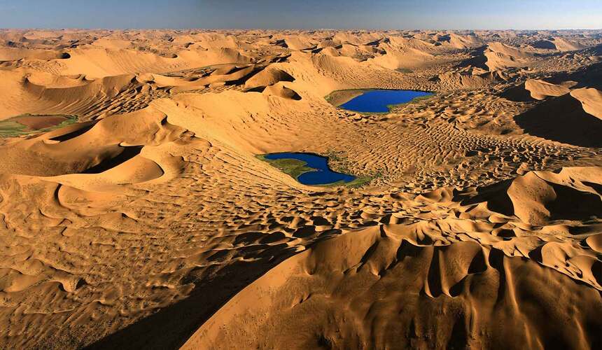 Towering sand dunes and desert lakes in the Badain Jaran Desert of Inner Mongolia