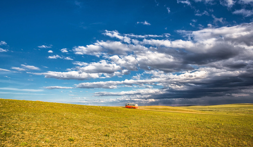Wide open grasslands with grazing horses at Xilamuren Grassland near Baotou, Inner Mongolia