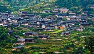 Traditional ethnic minority village nestled among karst mountains and lush countryside in Guizhou