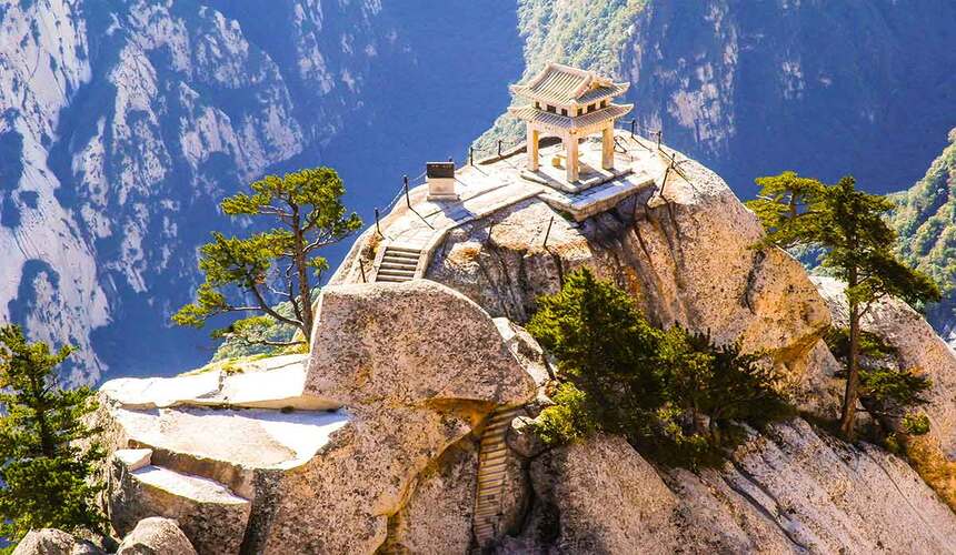 Steep granite cliffs and dramatic hiking trails at Mount Hua, China.