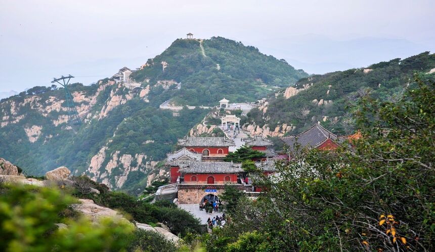 Sunrise over Mount Tai, China, with ancient stone steps leading to historic temples.
