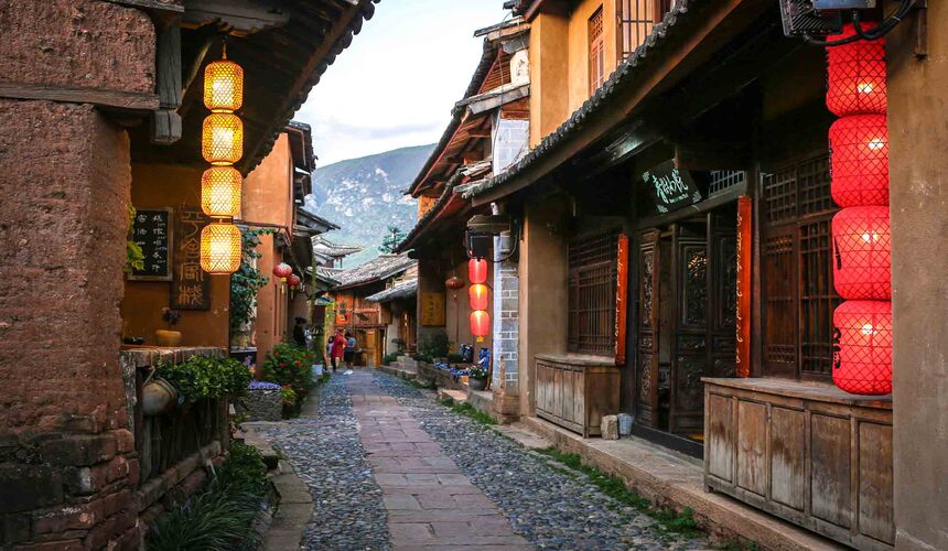 Historic market square and traditional buildings in Shaxi Ancient Town along the Ancient Tea Horse Road in Yunnan, China.