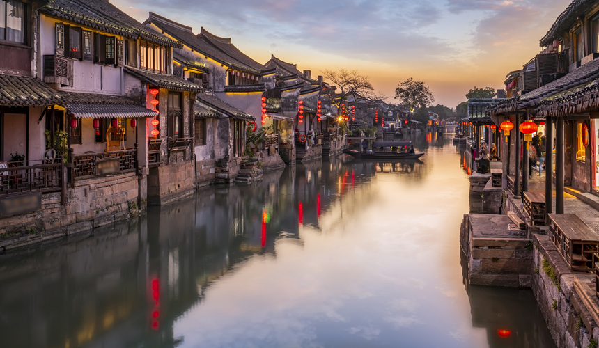 Covered walkways, ancient bridges, and canal-side houses in Xitang Ancient Town, Zhejiang, China.