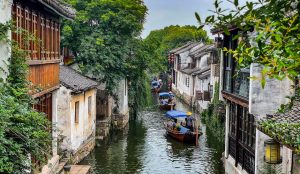 Stone bridges arching over quiet canals lined with traditional houses in Zhouzhuang Water Town, China.