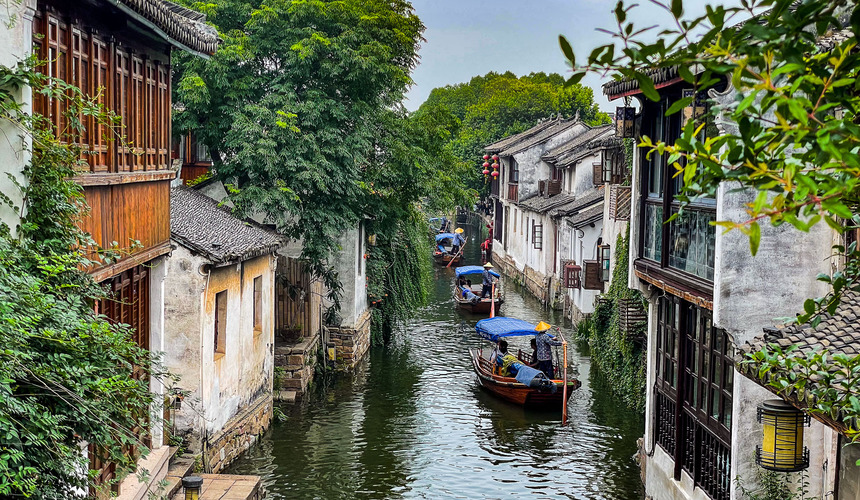 Stone bridges arching over quiet canals lined with traditional houses in Zhouzhuang Water Town, China.