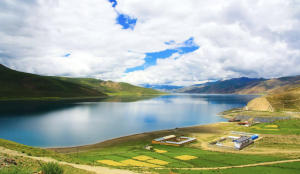 Panoramic view of the sacred Yamdrok Lake surrounded by snow-capped mountains in Tibet, China