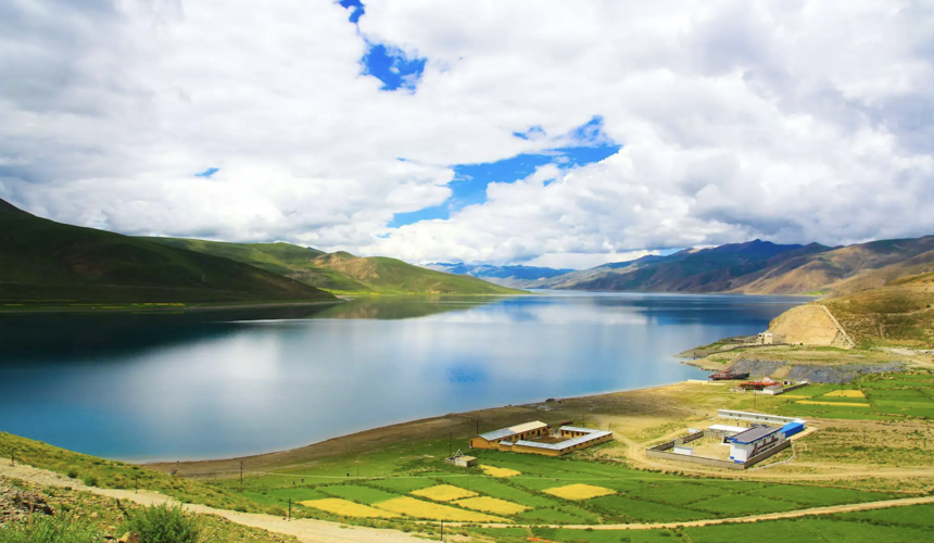 Panoramic view of the sacred Yamdrok Lake surrounded by snow-capped mountains in Tibet, China