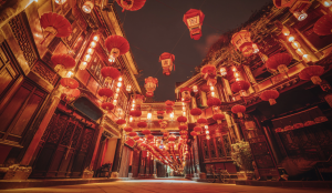 Bustling Jinli Ancient Street illuminated with red lanterns and traditional Sichuan-style buildings.