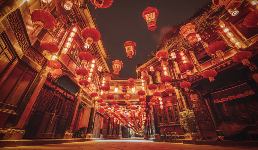 Bustling Jinli Ancient Street illuminated with red lanterns and traditional Sichuan-style buildings.