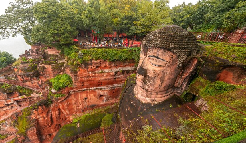 The towering Leshan Giant Buddha carved into a cliff overlooking the confluence of three rivers.
