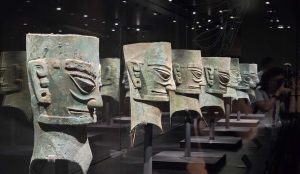 Bronze masks and ancient artifacts displayed at Sanxingdui Museum, revealing the mysteries of Shu civilization.