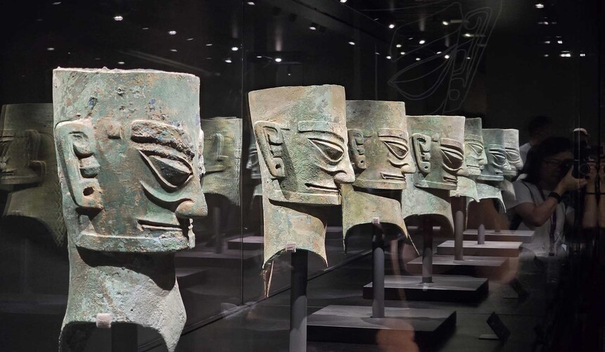 Bronze masks and ancient artifacts displayed at Sanxingdui Museum, revealing the mysteries of Shu civilization.