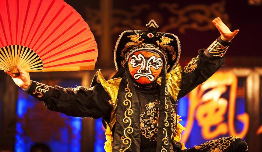 Sichuan Opera performer demonstrating the famous face-changing performance in Chengdu.